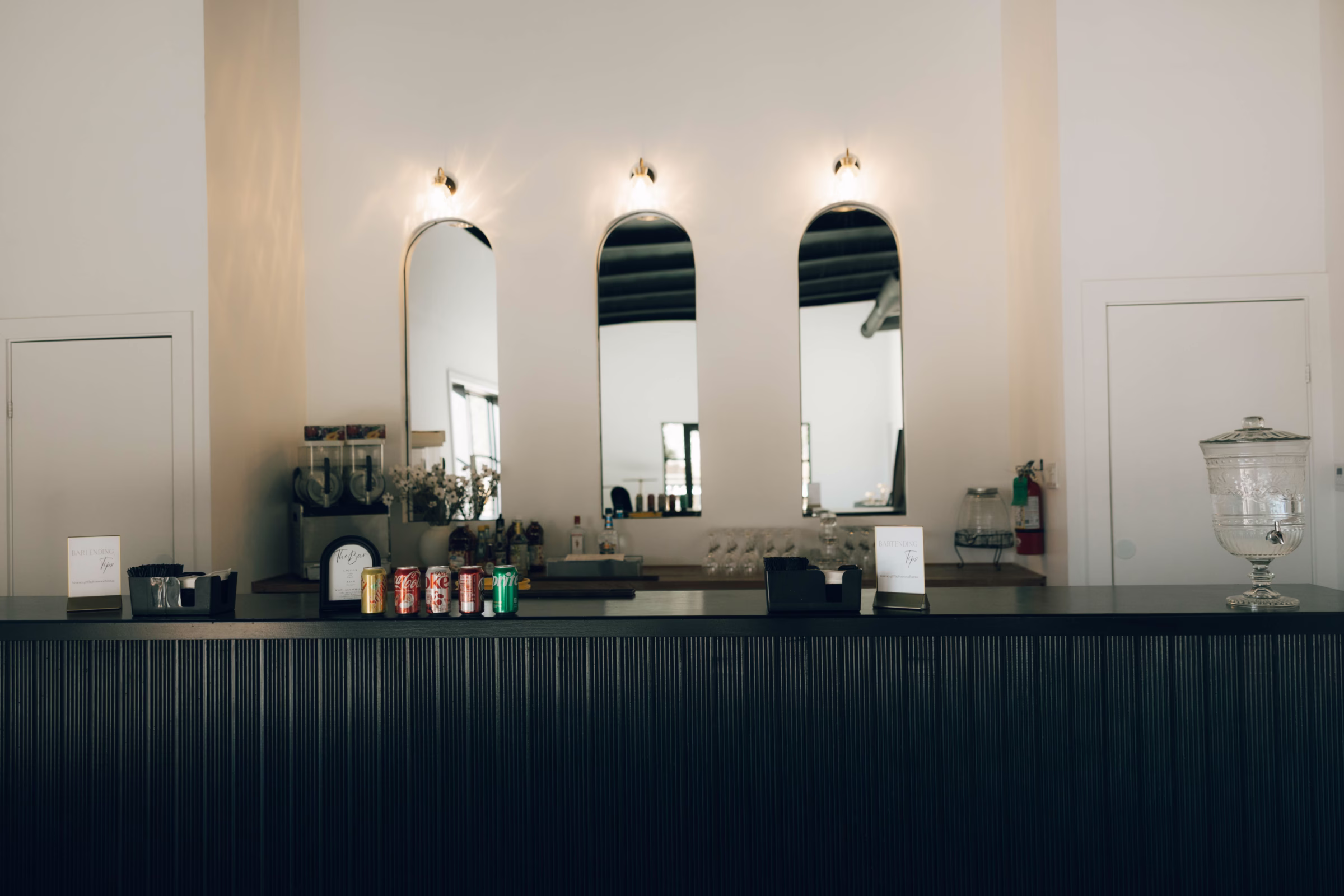Elegant reception bar setup with arched mirrors and floral arrangements at The Foxwood wedding venue in Hill Country Texas