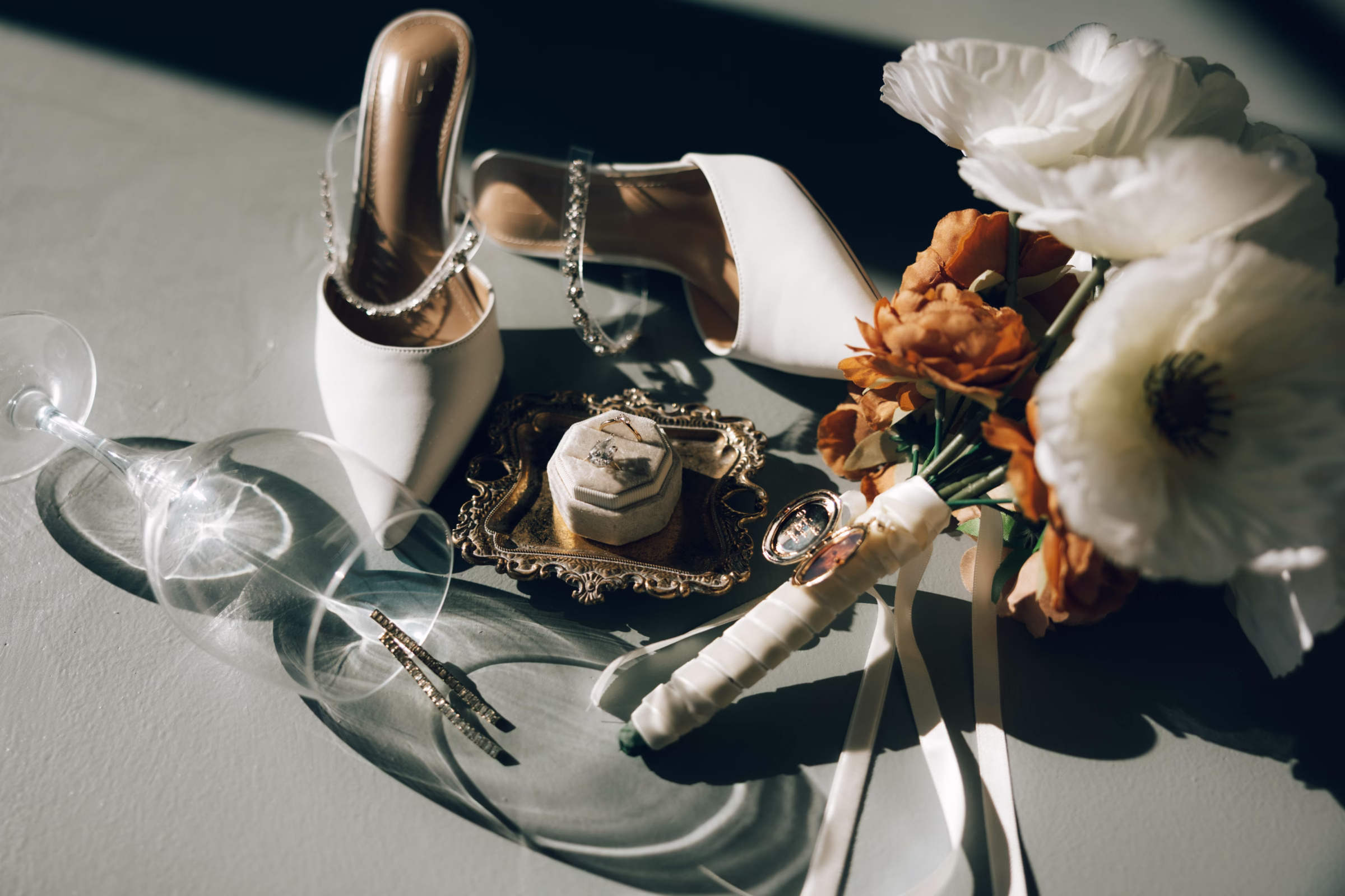 Elegant wedding details including white bridal shoes, jewelry, and floral arrangements at The Foxwood Hill Country Texas wedding venue